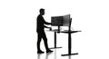 Programmer Silhouette Coding at Standing Desk with Multiple Monitors Royalty Free Stock Photo