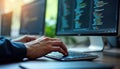 Programmer types code on computer keyboard. Modern workspace shows tech professionals work. Developer writes program code on pc