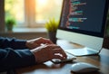 Programmer Typing Code on Desktop Computer
