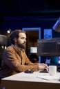 Programmer typing on keyboard, installing fortified code on PC