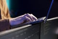 Programmer typing on laptop to fix system vulnerabilities, close up