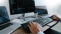 Programmer working On Computer In IT Office Typing Data Coding in software and checking code on computer screen Royalty Free Stock Photo