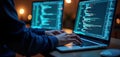 Programmer working on laptop in evening. Coding in multiple screens, developing software application. Closeup of hands on