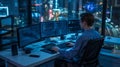 Programmer working on multiple monitors at night with city view Royalty Free Stock Photo