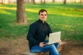 Programmer working in the park on laptop. Man sitting on bench Royalty Free Stock Photo