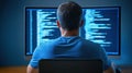 A programmer works late at night coding software on a large computer screen. Royalty Free Stock Photo