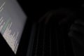 The programmer writes the program code at night in a dark room. Hands on laptop keyboard and software script on close-up screen. Royalty Free Stock Photo
