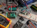 Programmers and Arduino with peripherals and expansion boards lie on a gray background. Do-It-Yourself