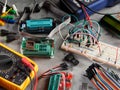 Programmers and Arduino with peripherals and expansion boards lie on a gray background. Do-It-Yourself