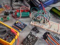 Programmers and Arduino with peripherals and expansion boards lie on a gray background. Do-It-Yourself