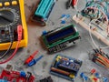 Programmers and Arduino with peripherals and expansion boards lie on a gray background