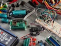 Programmers and Arduino with peripherals and expansion boards lie on a gray background