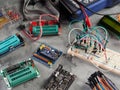 Programmers and Arduino with peripherals and expansion boards lie on a gray background