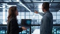 Programmers coding on laptop using artificial intelligence in server farm Royalty Free Stock Photo