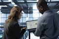 Programmers in data center workspace coding on laptop Royalty Free Stock Photo