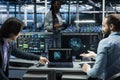 Programmers doing brainstorming in data center, using AI LLM assistant Royalty Free Stock Photo