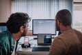 Programmers engrossed in deep collaboration, diligently working together to solve complex problems and develop Royalty Free Stock Photo