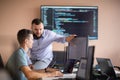 Programmers engrossed in deep collaboration, diligently working together to solve complex problems
