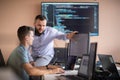 Programmers engrossed in deep collaboration, diligently working together to solve complex problems