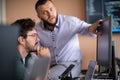 Programmers engrossed in deep collaboration, diligently working together to solve complex problems