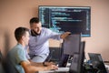 Programmers engrossed in deep collaboration, diligently working together to solve complex problems
