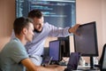 Programmers engrossed in deep collaboration, diligently working together to solve complex problems
