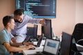 Programmers engrossed in deep collaboration, diligently working together to solve complex problems