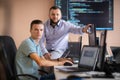Programmers engrossed in deep collaboration, diligently working together to solve complex problems