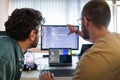 Programmers engrossed in deep collaboration, diligently working together to solve complex problems and develop