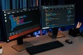 Programming code on computer two screen on desktop at neon light room. Infobahn. Royalty Free Stock Photo