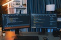 Programming code on computer two screen on desktop at neon light room. Infobahn. Royalty Free Stock Photo