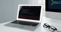 Programming code on laptop monitor and beside screen pc desktop. Tastemaker. Royalty Free Stock Photo