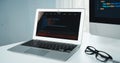 Programming code on laptop monitor and beside screen pc desktop. Tastemaker. Royalty Free Stock Photo