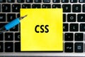 programming language inscription `CSS` on a yellow sheet of sticker paper on the background of a computer keyboard Royalty Free Stock Photo