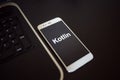 Programming language Kotlin for mobile development, concept. Smartphone near the laptop