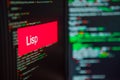 Programming language, Lisp inscription on the background of computer code. Royalty Free Stock Photo