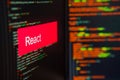 Programming language, React inscription on the background of computer code. Royalty Free Stock Photo