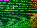 Programming text on dark screen. HTML5 concept macro backdrop in warm colors. HTML CSS3 source code on lcd screen with black