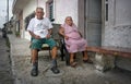 Progreso, Mexico - October 14, 2007: Old couple of Progreso residents sitting on their porch on a hot evening with tired