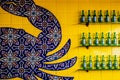 Yucatan Mexico - Interesting Design of Tavera tiles on wall of Mexican restaurant near beach with bottles of