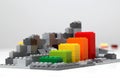 Progress chart made of bricks. Isometric composition of colourful toys on white table. Royalty Free Stock Photo