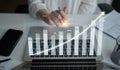 Progress in Financial Growth Chart with Hand Gesture over Laptop Displaying Data Insights and Analytics Visualization in Royalty Free Stock Photo