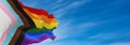 Progress LGBTQ rainbow flag waving in the wind at cloudy sky. Freedom and love concept. Pride month. activism, community and