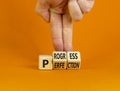 Progress or perfection symbol. Businessman turns cubes and changes the concept word `perfection` to `progress` on a beautiful Royalty Free Stock Photo