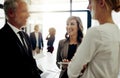 Progress is always positive. three businesspeople talking while standing in the office.