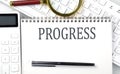 PROGRESS Text on notepad with calculator and keyboard Royalty Free Stock Photo