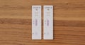 Progress of two Coronavirus antigen tests, side by side. One test becomes positive and one negative. Covid-19, self at home tests