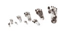 Progression of dirty footprints decreasing in size on a white surface, concept of growth or tracking Royalty Free Stock Photo