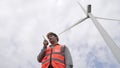 Progressive engineer working with the wind turbine, with the sky as background. Royalty Free Stock Photo