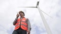 Progressive engineer working with the wind turbine, with the sky as background. Royalty Free Stock Photo